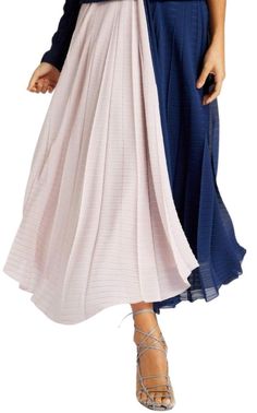 Supported by a crepe waistband, this 'Orvana' maxi skirt is draped with panels of navy and petal-pink georgette, pleated in multiple directions to enhance the lightness - something we can testify to by how beautifully it moved on the runway.Colourblock designCrepe GeorgettePleated in multiple directionsZip fastening through backFully linedFront and back slitDry cleanMade in UK Pleated Maxi Skirt For Evening, Elegant Pleated Flowy Maxi Skirt, Pink Pleated Maxi Skirt For Party, Flowy Party Maxi Skirt With Folds, Spring Draped Skirt With Folds And Flowy Fit, Evening Tiered Accordion Pleats Skirt, Spring Long Draped Skirt With Folds, Spring Draped Long Skirt With Folds, Spring Flowy Maxi Skirt With Folds