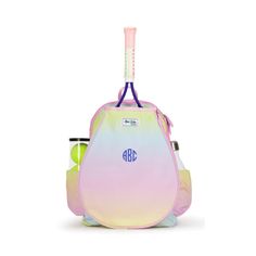 a pink and blue backpack with a toothbrush in the back, sitting on top of it