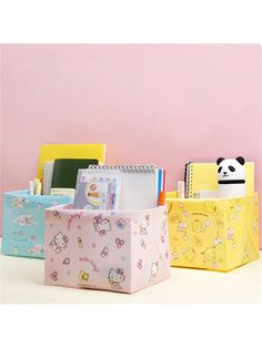 three small storage bins with cartoon characters on them