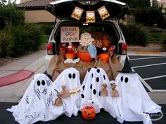 the back of a van decorated for halloween with ghost decorations and pumpkins in it