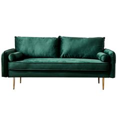 a green velvet couch with wooden legs and two pillows on the back, in front of a white background