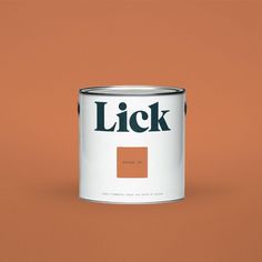 a brown paint can with the word lick on it's side and an orange background