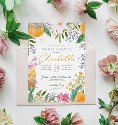 a floral bridal shower party with oranges, flowers and greenery on the table