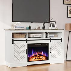 a white entertainment center with a fireplace and flat screen tv mounted on it's wall