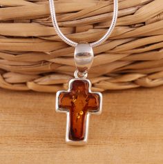 This is 925 Sterling Silver Cross Pendant & Genuine Baltic Amber.    925 stamped         Amber colour: cognac        Approx. pendant measures:                total length: 22mm               without bail: 16mm               width: 10mm Available on its own or with various length (16-26 Inch ) snake chain, please choose from the drop down menu at the top of the page.    Presented in gift box.    Thank you for looking! Classic Amber Necklace As Gift, Classic Amber Necklace Gift, Brown Cross Pendant Necklace As Gift, Classic Amber Necklace For Gift, Brown Cross Pendant Necklace For Gift, Classic Orange Jewelry As Gift, Classic Orange Necklace For Gift, Classic Orange Necklace For Gifts, Classic Orange Jewelry For Gift