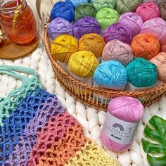 several balls of yarn sitting next to each other in a basket on top of a table