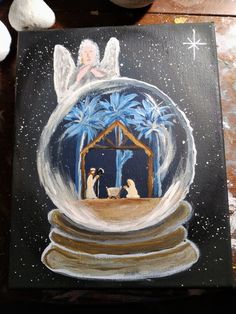 an acrylic painting of a nativity scene in a snow globe with palm trees