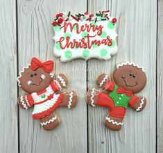 two decorated gingerbread cookies sitting next to each other