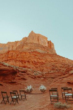 chairs are set up in the desert for an outdoor wedding ceremony at red rocks state park