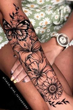 a woman's arm with flowers and butterflies on it