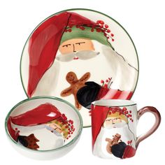 a santa clause plate with two cups and saucers, one has a gingerbread man on it