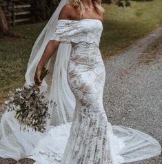 a woman in a wedding dress is walking down the road