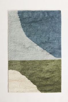 an abstract rug with blue, green and white colors