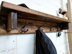 a coat rack with hooks and an umbrella hanging from it