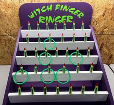 a display case with rings and candles in the shape of o - rings that spell out'witch finger ringers '