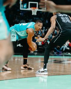 two basketball players on the court during a game