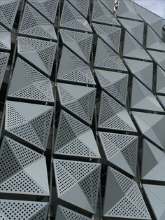 the facade of an office building with perforated metal panels