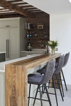 a kitchen bar with stools next to it