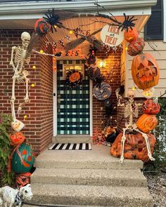 a front porch decorated for halloween with pumpkins and decorations