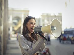 a woman holding a megaphone up to her face