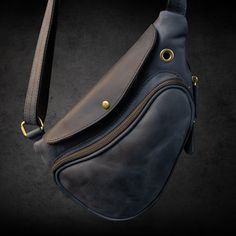 "The Fit Bag Indigo model is made of cowhide leather with a \"Crazy Horse\" finish. The peculiarity of this material is that in the process of operation, the effect of \"aging\" appears, which gives the product a special charm and charisma. Hardware, \"old brass\" colors, also play an important role in the vintage look of the accessory. It has two main compartments, a shoulder strap with leather inserts and a protective flap.  It is possible to increase the volume of the bag by opening the zipper on the outside.  Size 32 cm × 20 cm × 5 cm. Belt circumference 120 cm. Whether it's a casual day out or a business meeting, this crossbody bag offers convenience and style. It's also a great option for a Father's Day gift or a personalized gift set for men. With its adjustable strap and compact de Leather Pouch Chest Bag For Travel, Leather Shoulder Chest Bag For Everyday Use, Leather Chest Bag For Daily Use, Leather Chest Bag With Leather Lining For Travel, Soft Leather Chest Shoulder Bag, Leather-backed Crossbody Chest Bag For Daily Use, Leather Backed Crossbody Chest Bag For Daily Use, Leather Chest Bag With Leather Lining For Everyday Use, Leather Chest Bag For Everyday Use