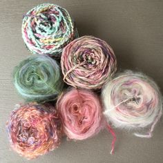 several skeins of yarn sitting on top of each other