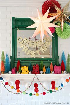 a mantle decorated with christmas decorations and paper stars