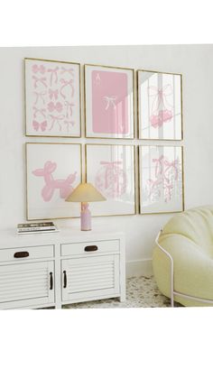 a living room with white furniture and pink wall art on the walls, along with a lamp