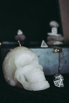 a white candle sitting on top of a black table