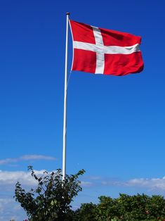 a flag flying in the wind on a sunny day