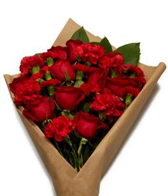 a bouquet of red flowers is wrapped in brown paper