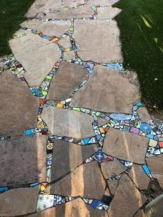 a walkway made out of different colored glass tiles