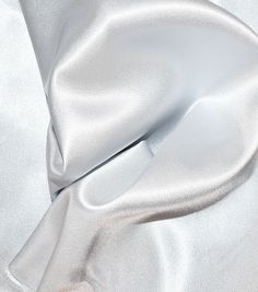 a white satin material is shown in close up