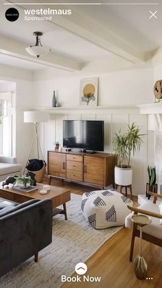 a living room filled with furniture and a flat screen tv on top of a fireplace