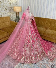 a pink bridal gown on display in a living room