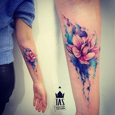 two people with tattoos on their arms and legs, one is holding the other's hand