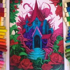 a drawing of a house surrounded by flowers and roses with colored crayons next to it