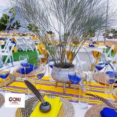 the table is set with wine glasses and place settings for an outdoor dinner or party