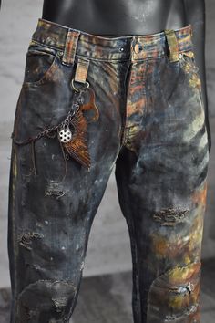 Post-Apocalyptic Rusty Men's Jeans with Bottle Opener Chain - Dystopian Clothing - Distressed Outfit - Wasteland Weekend - LARP Pants Embrace the post-apocalyptic fashion with these rusty men's jeans, expertly dyed and distressed to exude a vintage vibe. The jeans feature a decorative chain, adorned with a functional bottle opener, making it a perfect accessory for a night out with friends or a camping trip. The unique style and attention to detail make these jeans a standout addition to any wardrobe. The rugged design and comfortable fit make them perfect for any adventure in the great outdoors. Don't miss out on the chance to own a piece of post-apocalyptic fashion with these stylish and functional jeans. Please Note: The pants pictured above are representative of the style. Individual p Post Apocalyptic Clothing, Distressed Outfit, Apocalyptic Clothing, Wasteland Weekend, Apparel Design Inspiration, Patch Pants, Post Apocalyptic Fashion, Apocalyptic Fashion, Biker Pants