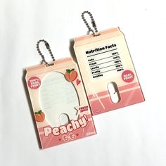 two tags that say peachy and one has an image of a strawberry on it