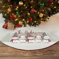 a christmas tree with three snowmen under it