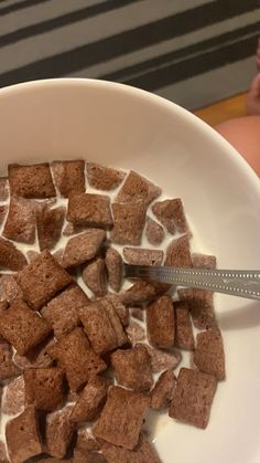 a white bowl filled with marshmallows on top of a table