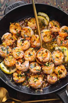 a skillet filled with cooked shrimp and vegetables