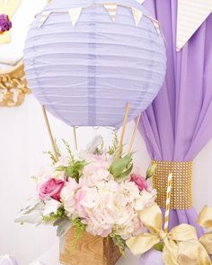 there is a vase with flowers in it next to a paper lantern and other decorations