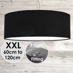 a black lamp hanging from the ceiling next to a sticker that says xxl