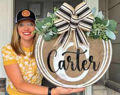 a woman holding up a wooden sign with the word,'center'on it