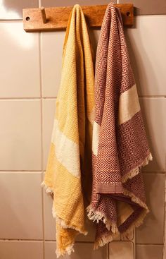 two towels are hanging on a towel rack