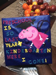 a blue bag with a peppa pig on it and some fruit in the background