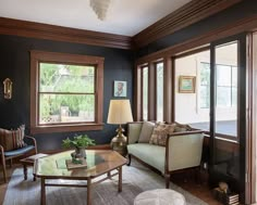 a living room filled with furniture and windows