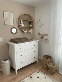 a baby's room with a dresser, crib and toys on the floor